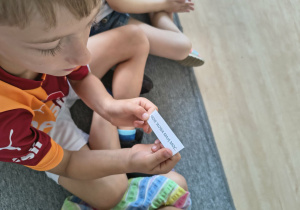 Chłopiec prezentuje wylosowane zdanie afirmacyjne