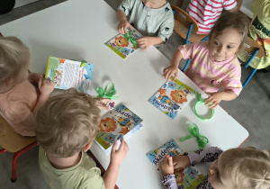 Dzieci oglądają upominki otrzymane od solenizantki