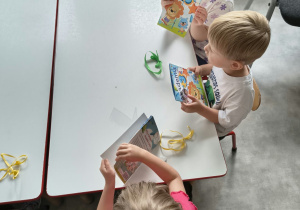 Dzieci oglądają upominki otrzymane od solenizantki