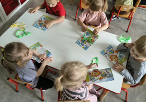 Dzieci oglądają upominki otrzymane od solenizantki