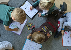 Dzieci kolorują postacie Liska Fenka i Kotka Maksa