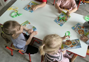 Dzieci oglądają upominki otrzymane od solenizantki