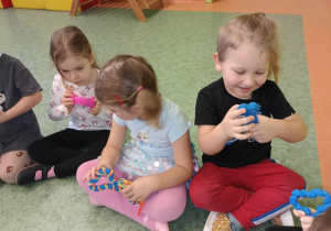 Dzieci manipulują zabawkami dla pieska