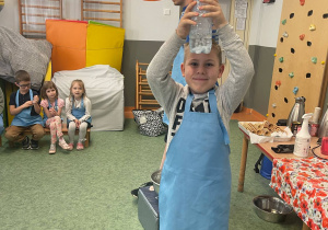 Chłopiec z balonem na butelce podczas doświadczeń na warsztatach z kuchni molekularnej