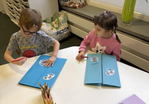 dzieci wykonują lapbook o jesiennej pogodzie