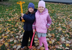Dziewczynki pozują do zdjęcia w jesiennym ogrodzie przedszkolnym