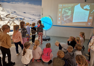 dzieci szukają zwierząt na podświetlanym globusie