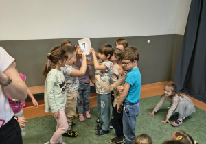 Dzieci prezentują odnalezioną cyfrę 7
