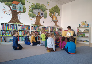 dzieci oglądają teatrzyk w wykonaniu pana bibliotekarza