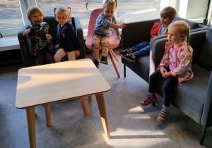 Dzieci siedzą na fotelach w czytelni Biblioteki Ferment