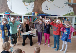 Dzieci pozują do zdjęcia w maskach Superbohaterów