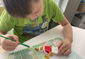 dzieci malują farbami gipsowe figurki Lego